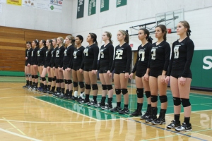 Varsity volleyball team lines up for the National Anthem at Sheldon High school in Eugene, OR.  Photo by Brad Cook
